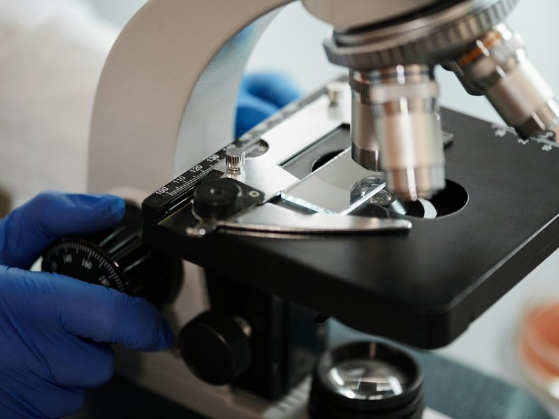 Female researcher at the microscope in the laboratory, symbol of nanotechnology